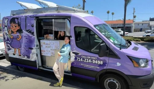 Haley next to the purple Sassy Boba Greatea van with the side door open